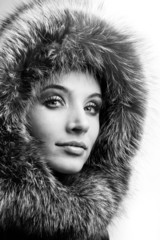 Portrait of the beautiful young woman with a fur hood