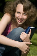 Happy student with pen and copy-book.
