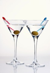 Two glasses of martini with olives