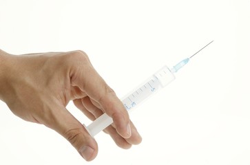 Hand holding a syringe