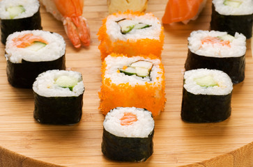 Different types of sushi on a bamboo plate