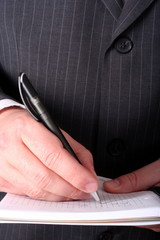 Businessman hand signing document 