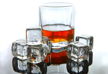 Whiskey in glass with ice cubes