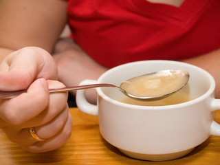 Woman eating soup