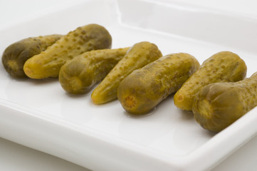 Fresh dill pickles on plate.