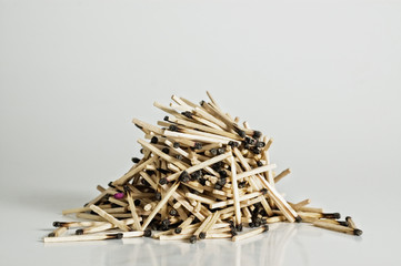 Burned wooden matches on white matches.