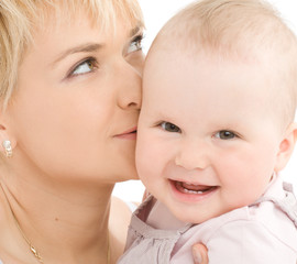 Mother kiss her baby girl and dreaming