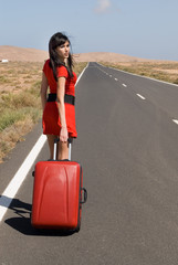 woman on the road with his suitcase