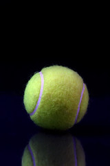 Tennis ball on black background