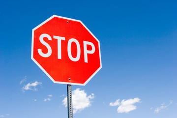 Stop sign against blue sky