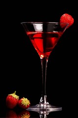 Red cocktail with strawberries on black background