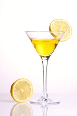 Yellow cocktail with lemon on white background