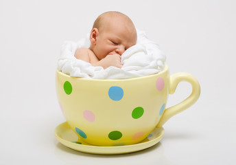Newborn in yellow cup