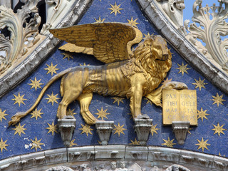 Golden Venetian lion on San Marco cathedral