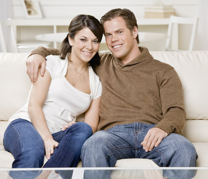 Portrait of a young couple hugging on a couch