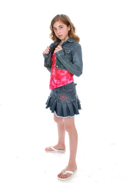 Defiant looking young girl wearing a short denim mini skirt 
