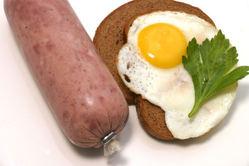 sausage balooon with fried egg on bread