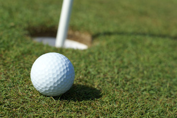 Golfball in front of the hole