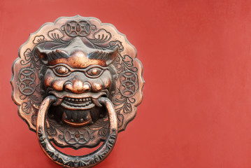 lion knocker on red door