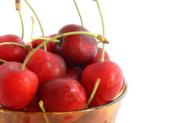 A plate with cherries on white background
