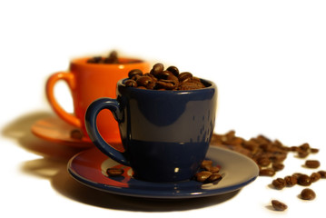 two espresso cups with coffee beans