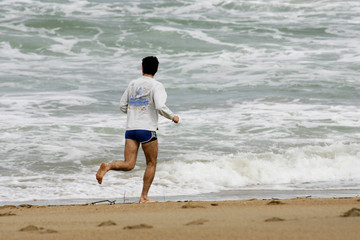 homme entrain de courir sur la plage