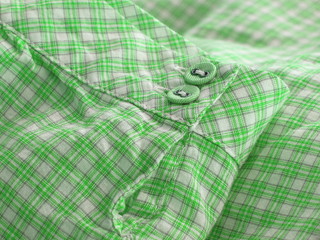 Close up of a checkered shirt cuff.