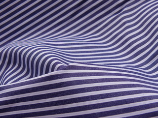 Striped, diagonal fabric close up background. 