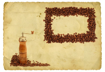 Coffee grinder and coffee beans frame on vintage background
