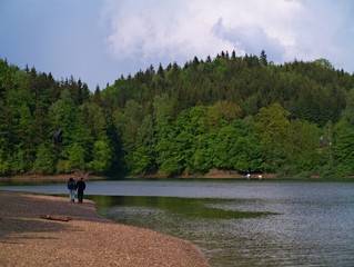 young couple walking at the lakeside