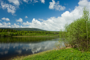 Summer landscape. Clouds above the river.