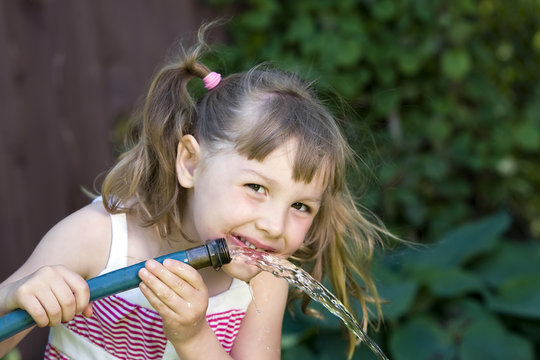 Child Drinking From Garden Hose