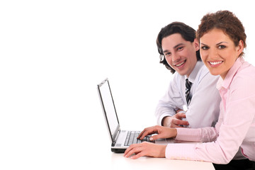 Businesswoman and businessman working on laptop computer