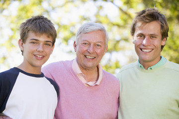 Grandfather with son and grandson smiling