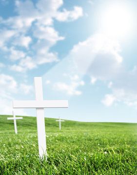 White Cross In Grass Field With Heavenly Beam Of Light