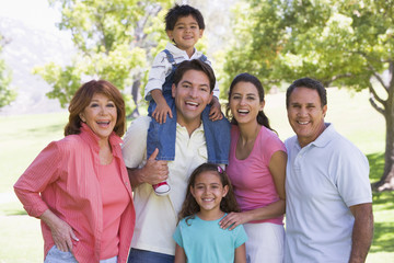 Extended family standing outdoors smiling