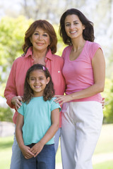Grandmother with adult daughter and grandchild in park
