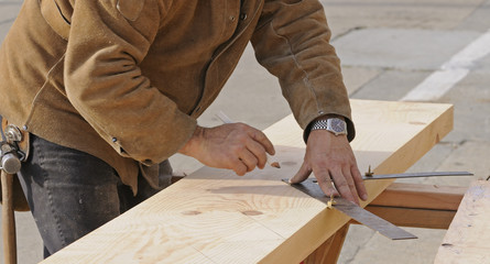 Carpenter marking out steps on a stringer