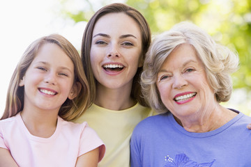 Grandmother with adult daughter and grandchild in park