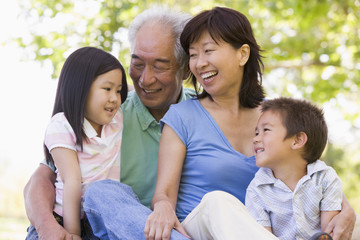 Grandparents laughing with grandchildren - obrazy, fototapety, plakaty