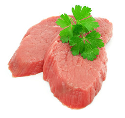 two sliced meat with leaf of green parsley