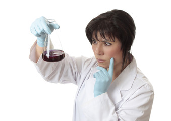 Female scientist analysing solution in erlenmeyer flask
