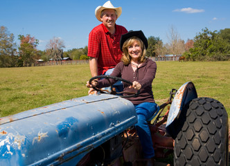 Mature Farm Couple on Tractor