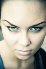 Fototapeta na wymiar Woman with green eyes mysterious portrait