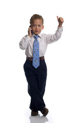 Young boy dressed as businessman talks on the mobile phone - iso