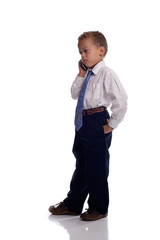 Young boy dressed as businessman talks on the mobile phone - iso