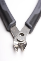 a black wire cutter with shallow depth of view