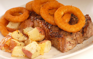 Seared New York cut strip steak with onion rings