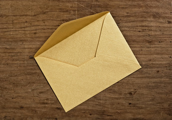 Open golden envelope, close up, studio shot.