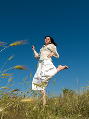 Happy Young Lady Runs Through Field